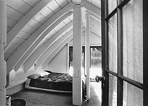 Sleeping loft. Rafters are 2-by-12's cut to curved shape with chainsaw.