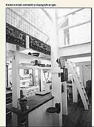 Kitchen is on left, with ladder to sleeping lofts at right.